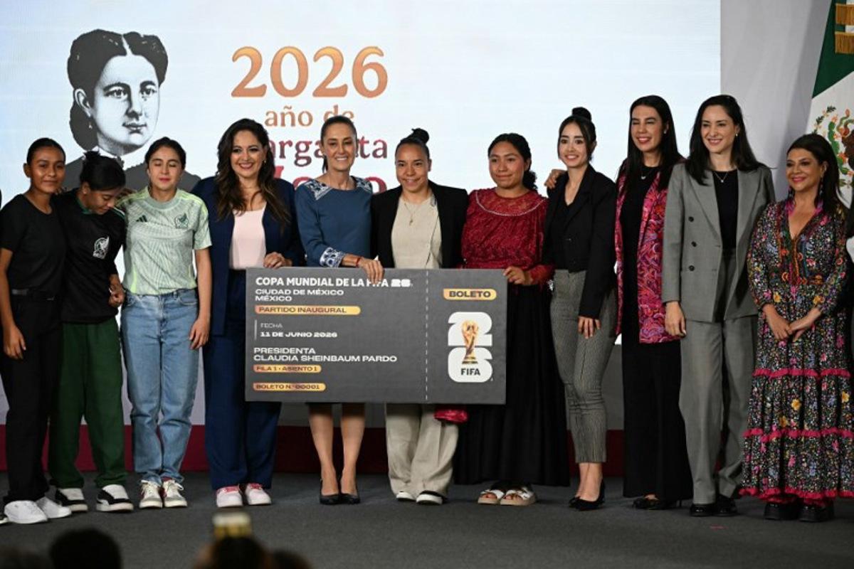 Mexico's President Claudia Sheinbaum (C) poses with the contest winners alongside Mexico City Mayor Clara Brugada (R) and other guests during the awards ceremony of the "Represent Mexico at the World Cup Opening" contest, launched in March, at the National Palace in Mexico City on May 29, 2026.  YURI CORTEZ / AFP