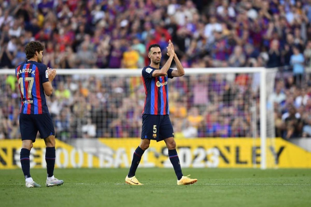 Barcelona's Spanish midfielder Sergio Busquets applauds as he leaves the pitch during the Spanish league football match between FC Barcelona and RCD Mallorca at the Camp Nou stadium in Barcelona on May 28, 2023. Sergio Busquets leaves Barcelona, ending a highly successful era at the club. The 34-year-old was a central figure in Barcelona's golden era winning a host of trophies including the Champions League three times.  Pau BARRENA / AFP