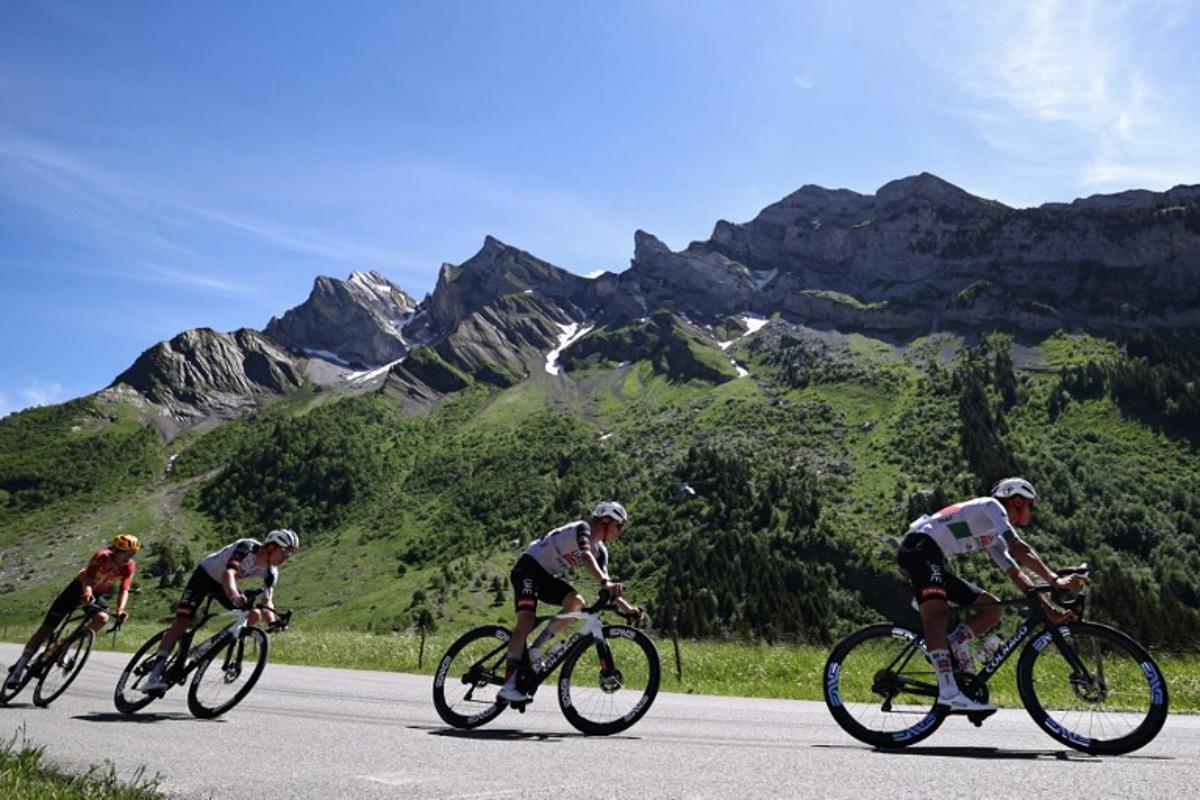 UAE Team Emirates XRG's Mexican rider Isaac Del Toro Romero (R) cycles in the descent of Col des Aravis during the 8th and final stage of the Tour Auvergne-Rhone-Alpes cycling race (formerly known as the Criterium du Dauphine), 120,1km between Beaufort and Plateau de Solaison, in the French Alps on June 14, 2026.  Anne-Christine POUJOULAT / AFP