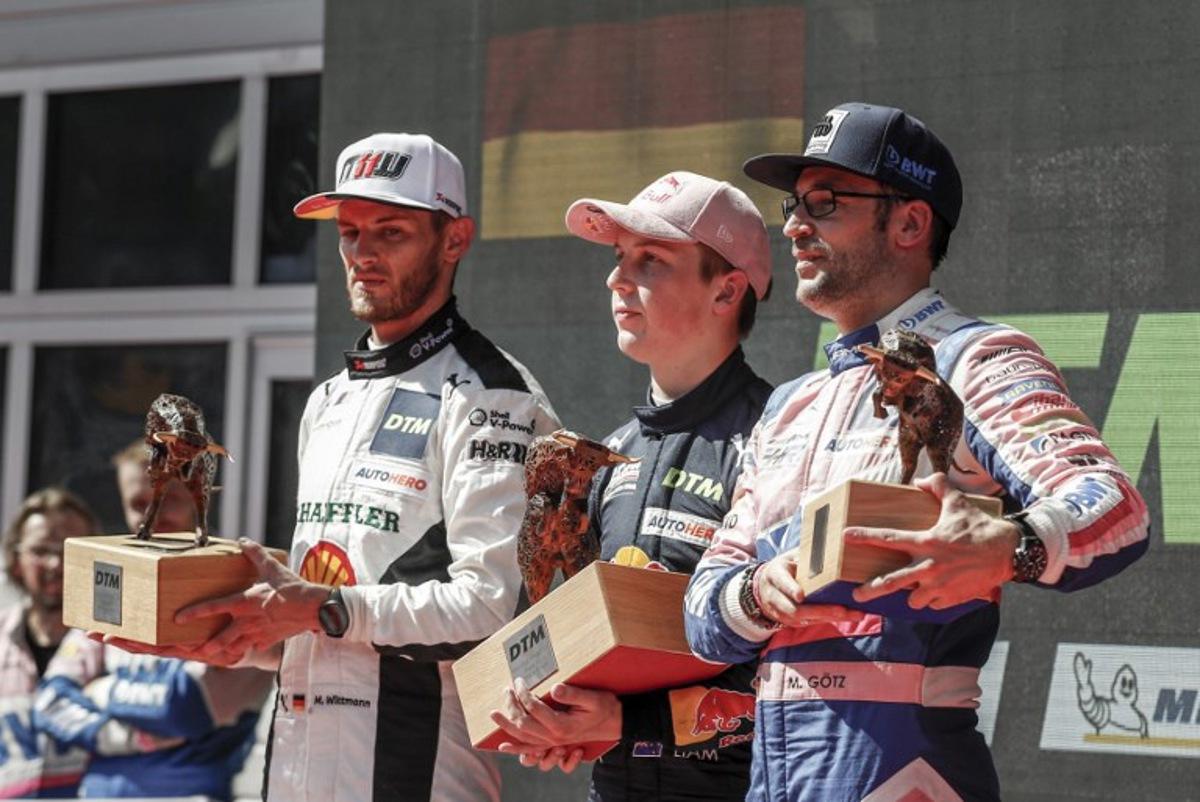 Second placed Germany's Marco Wittmann of the Walkenhors Motorsport Team (L), first placed New Zealand's Liam Lawson of the Red Bull Alphatauri AF Corse Team and third placed Germany's Maximilian Goetz of the Haupt Racing Team Team stand on the podium during the winners' ceremony after the end of the second race of the DTM of Austria, on September 5, 2021 at the Red Bull Ring in Spielberg, Austria.   ERWIN SCHERIAU / APA / AFP
