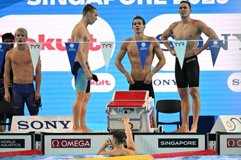 Neutral Athlete's team Neutral Athlete swimmer Andrei Minakov, Neutral Athlete swimmer Miron Lifintsev, Neutral Athlete swimmer Kirill Prigoda and Neutral Athlete swimmer Egor Kornev react after winning the   men's 4x100m medley relay swimming event during the 2025 World Aquatics Championships in Singapore on August 3, 2025.  Manan VATSYAYANA / AFP