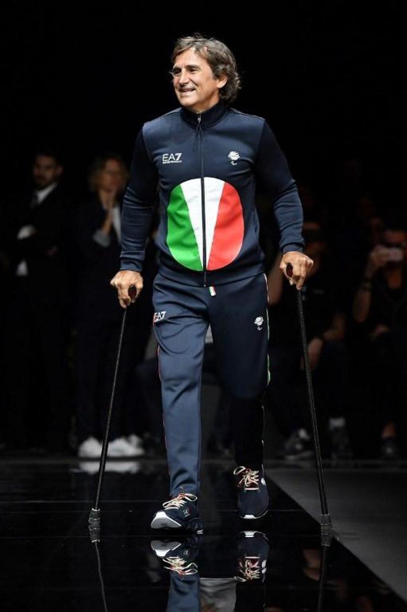 Italian professional racing driver and paracyclist, Alessandro Zanardi presents a creation for fashion house Emporio Armani during the presentation of its men's spring/summer 2020 fashion collection in Milan on June 15, 2019.   Marco Bertorello / AFP