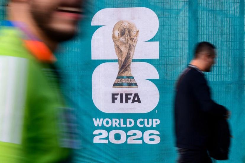 Pedestrians walk past an official competition logo on a fence ahead of the 2026 World Cup Group A football match between Mexico and South Africa at the Mexico City Stadium in Mexico City on June 11, 2026.  Rodrigo Oropeza / AFP