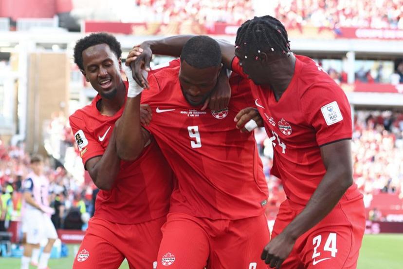 Canada's forward #09 Cyle Larin (C) is congratulated by teammates after scoring a goal during the 2026 World Cup Group B football match between Canada and Bosnia and Herzegovina at the Toronto Stadium in Toronto on June 12, 2026.  Cole Burston / AFP