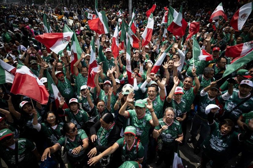 People take part in a Guinness World Record attempt for the world's largest Mexican Wave in Mexico City on June 6, 2026.  Carl de Souza / AFP