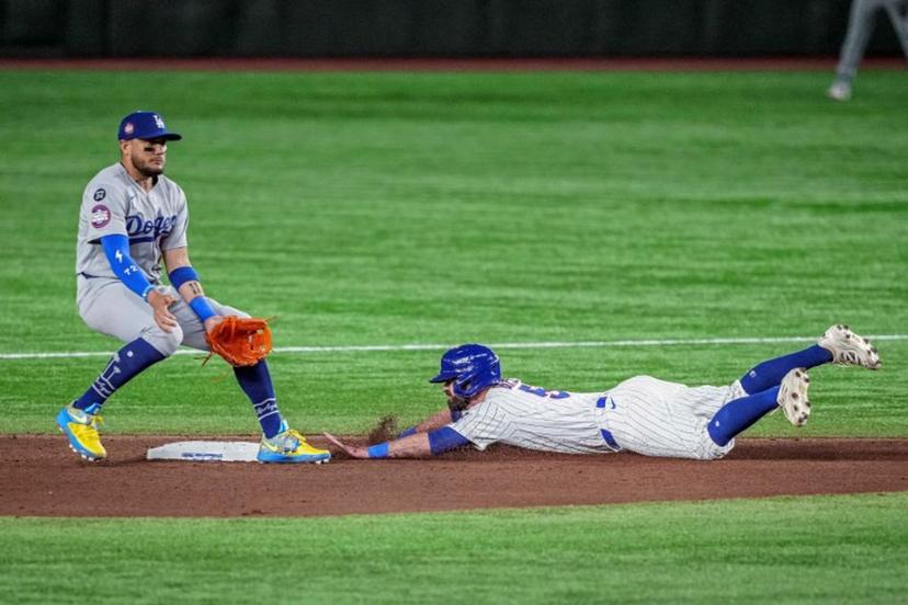 Chicago Cubs's Jon Berti (R) steals second base in the eighth inning during the baseball game between Los Angeles Dodgers and Chicago Cubs in the MLB Tokyo Series at the Tokyo Dome in Tokyo on March 18, 2025. Shohei Ohtani and the World Series champion Los Angeles Dodgers started the new Major League Baseball season with a win, beating the Chicago Cubs 4-1 in Tokyo on March 18. Yuichi YAMAZAKI / AFP