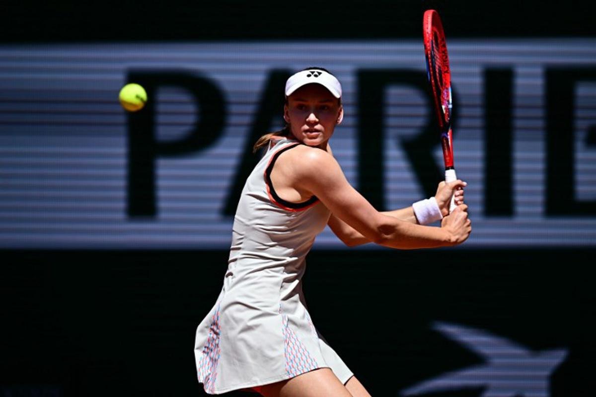 Kazakhstan's Elena Rybakina plays a backhand return to Slovenia's Veronika Erjavec during their women's singles match on day 2 of the French Open tennis tournament on Court Philippe-Chatrier at the Roland-Garros Complex in Paris on May 25, 2026.  JULIEN DE ROSA / AFP
