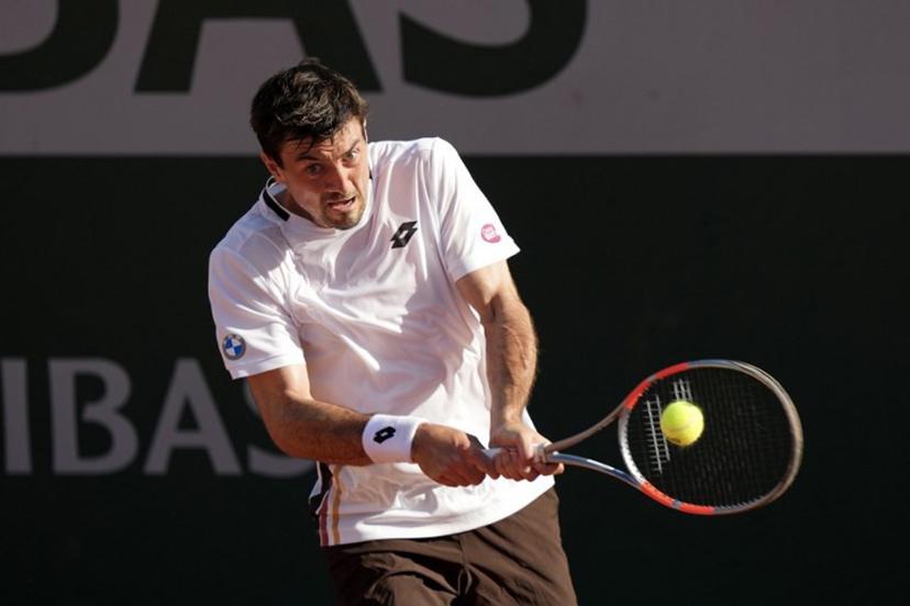 Austria's Sebastian Ofner plays a backhand return to Italy's Luciano Darderi during their men's singles match on day 3 of the French Open tennis tournament at the Roland-Garros Complex in Paris on May 26, 2026.  Dimitar DILKOFF / AFP