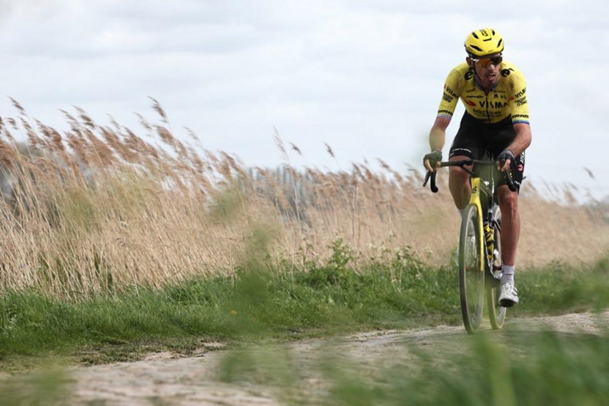 Team Visma - Lease a Bike's French rider Christophe Laporte cycles on a cobblestone sector during the 123rd edition of the Paris-Roubaix one-day classic cycling race, 258.3 km between Compiègne and Roubaix, northern France, on April 12, 2026.   Anne-Christine POUJOULAT / AFP