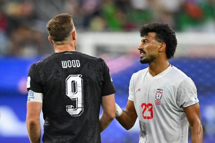 New Zealand's forward #09 Chris Wood and Iran's defender #03 Ehsan Hajsafi talk during the 2026 World Cup Group G football match between Iran and New Zealand at Los Angeles Stadium in Inglewood on June 15, 2026.   Patrick T. Fallon / AFP