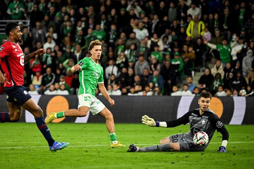 Saint-Etienne's Belgian forward #32 Lucas Stassin's (C) kicks the ball saved by Lille's French goalkeeper #30 Lucas Chevalier (R) during the French L1 football match between Saint-Etienne (ASSE) and Lille (LOSC) at the Geoffroy Guichard stadium in Saint-Etienne, on September 13, 2024.  JEFF PACHOUD / AFP
