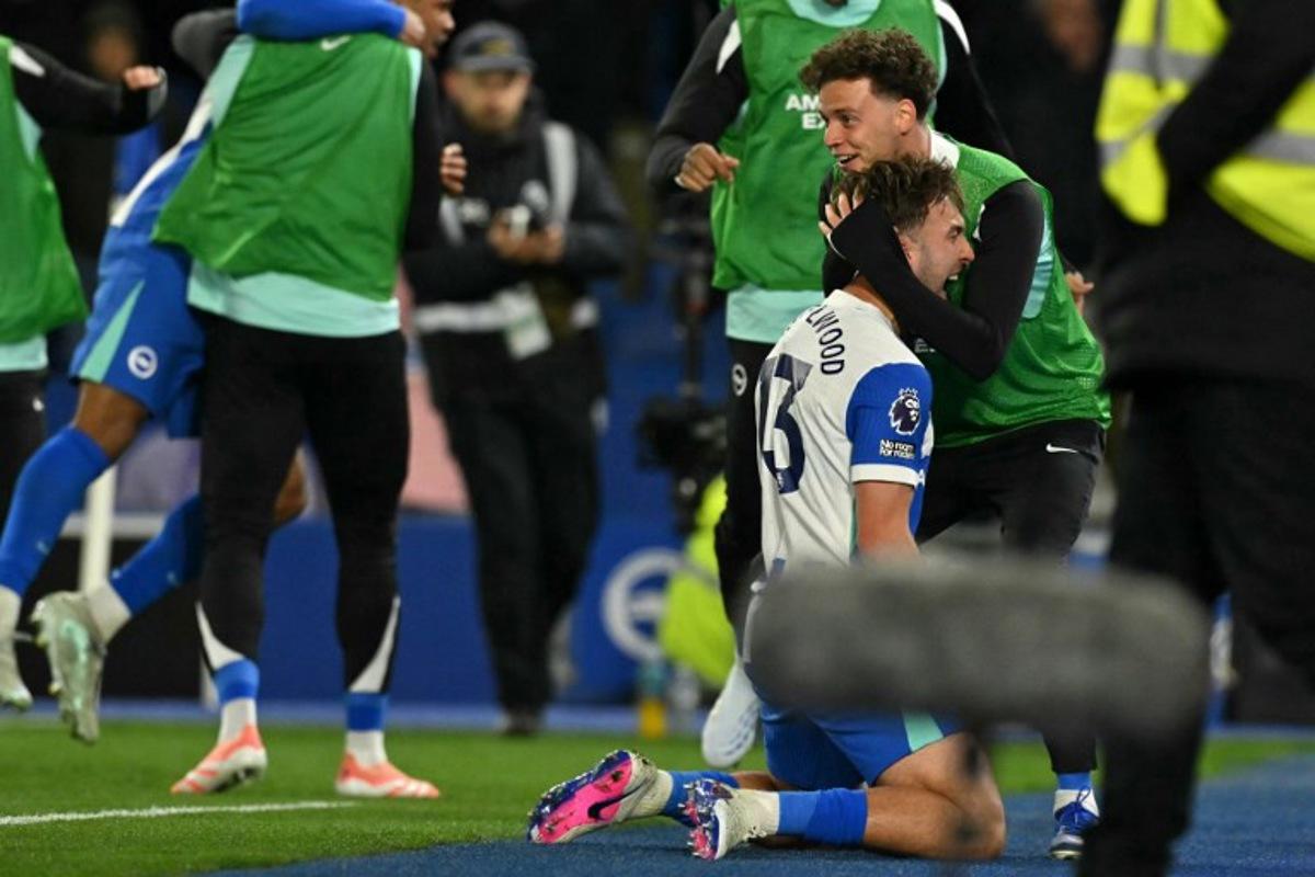 Brighton's English midfielder #13 Jack Hinshelwood (2R) celebrates with Brighton's substitutes after scoring their second goal during the English Premier League football match between Brighton and Hove Albion and Chelsea at the American Express Community Stadium in Brighton, southern England on April 21, 2026.  Glyn KIRK / AFP