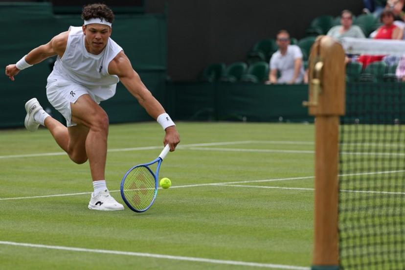 US player Ben Shelton returns the ball to Finland's Otto Virtanen during their men's singles first round tennis match on the second day of the 2026 Wimbledon Championships at The All England Lawn Tennis and Croquet Club in Wimbledon, southwest London, on June 30, 2026.  Adrian Dennis / AFP