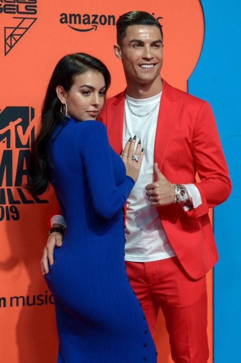 Juventus' Portuguese forward Cristiano Ronaldo (R) and his wife Georgina Rodriguez pose on the red carpet upon their arrival to the MTV Europe Music Awards at the FIBES Conference and Exhibition Centre of Seville on November 3, 2019.  CRISTINA QUICLER / AFP