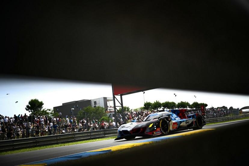 This photograph shows BMW M Team WRT's car driven by Danish Kevin Magnussen, Italian Raffaele Marciello and Belgian Dries Vanthoor during the 94th edition of the 24 Hours of Le Mans at the Le Mans circuit, north-western France on June 13, 2026.  Lou BENOIST / AFP