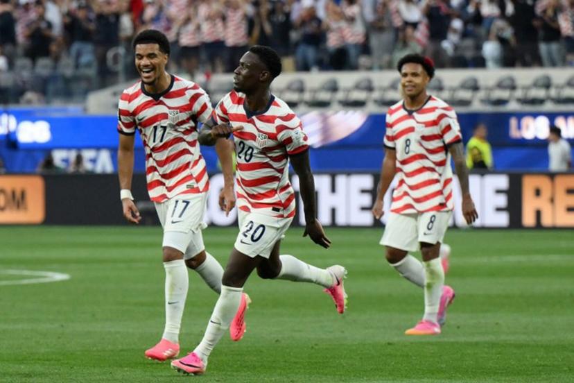 US forward #20 Folarin Balogun (C) celebrates scoring his team's third goal during the 2026 World Cup Group D football match between USA and Paraguay at the Los Angeles Stadium in Inglewood on June 12, 2026.  Patrick T. Fallon / AFP