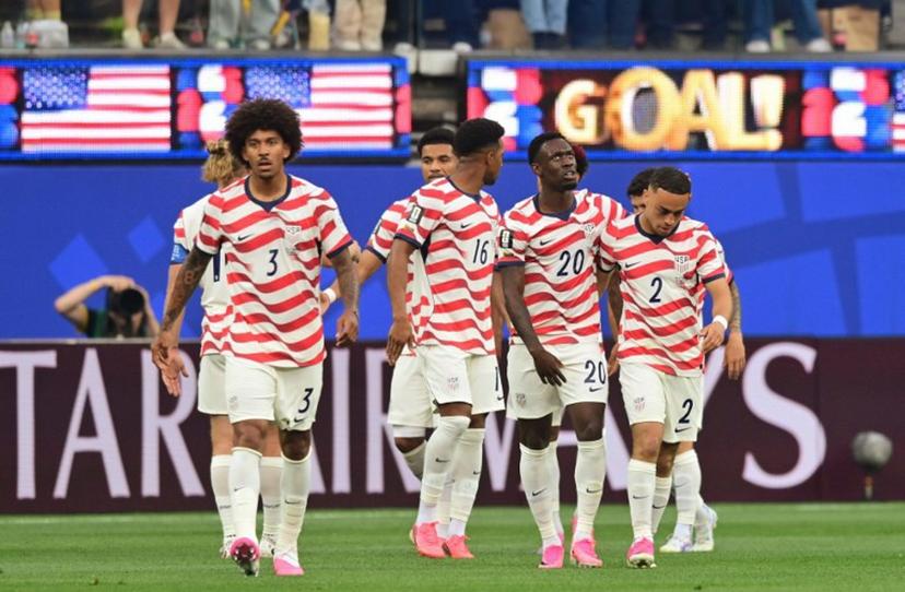US defender #16 Alex Freeman, forward #20 Folarin Balogun and defender #02 Sergino Dest celebrate their team's first goal scored own goal by Paraguay's midfielder #16 Damian Bobadilla during the 2026 World Cup Group D football match between USA and Paraguay at the Los Angeles Stadium in Inglewood on June 12, 2026.  Frederic J. BROWN / AFP