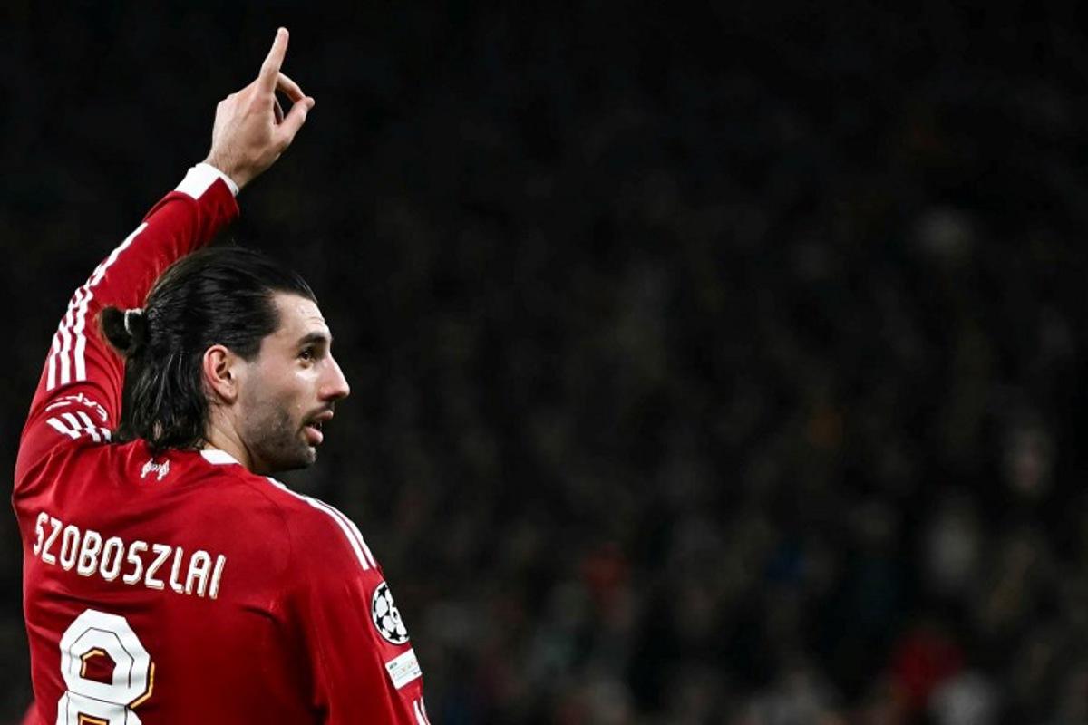 Liverpool's Hungarian midfielder #08 Dominik Szoboszlai celebrates scoring his team's first goal during the UEFA Champions League, round of 16 second leg football match between Liverpool and Galatasaray at Anfield in Liverpool, north-west England on March 18, 2026.  Paul ELLIS / AFP