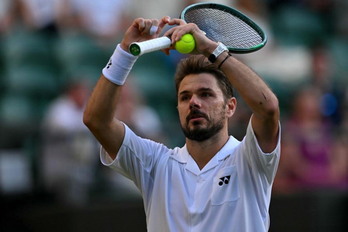 Switzerland's Stan Wawrinka gestures a heart during their men's singles first round tennis match on the second day of the 2026 Wimbledon Championships at The All England Lawn Tennis and Croquet Club in Wimbledon, southwest London, on June 30, 2026.  Glyn KIRK / AFP