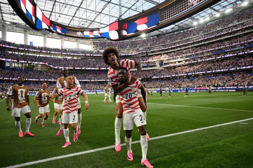 US forward #20 Folarin Balogun celebrates with teammates after scoring his team's third goal during the 2026 World Cup Group D football match between USA and Paraguay at the Los Angeles Stadium in Inglewood on June 12, 2026.  Patrick T. Fallon / AFP