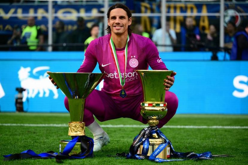 Inter Milan's Swiss goalkeeper #1 Yann Sommer poses with both trophies for the Italian Cup and the 21st scudetto (Italian Championship victory) at San Siro stadium after the Italian Serie A football match between Inter Milan and Hellas Verona in Milan, on May 17, 2026.  Marco BERTORELLO / AFP