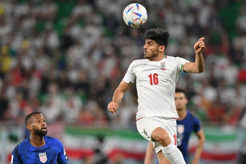 Iran's midfielder #16 Mehdi Torabi heads the ball during the Qatar 2022 World Cup Group B football match between Iran and USA at the Al-Thumama Stadium in Doha on November 29, 2022.  Glyn KIRK / AFP