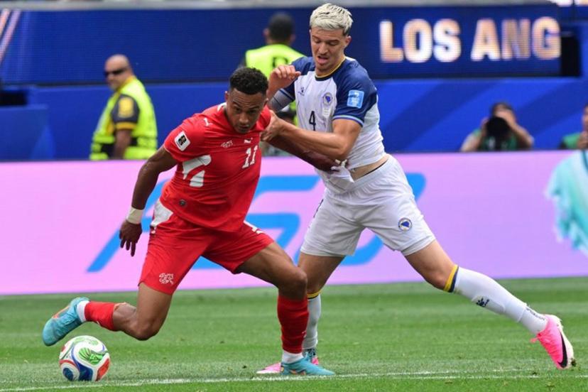 Switzerland's forward #11 Dan Ndoye and Bosnia-Herzegovina's defender #04 Tarik Muharemovic fight for the ball during the 2026 World Cup Group B football match between Switzerland and Bosnia and Herzegovina at Los Angeles Stadium in Inglewood on June 18, 2026.   Frederic J. Brown / AFP