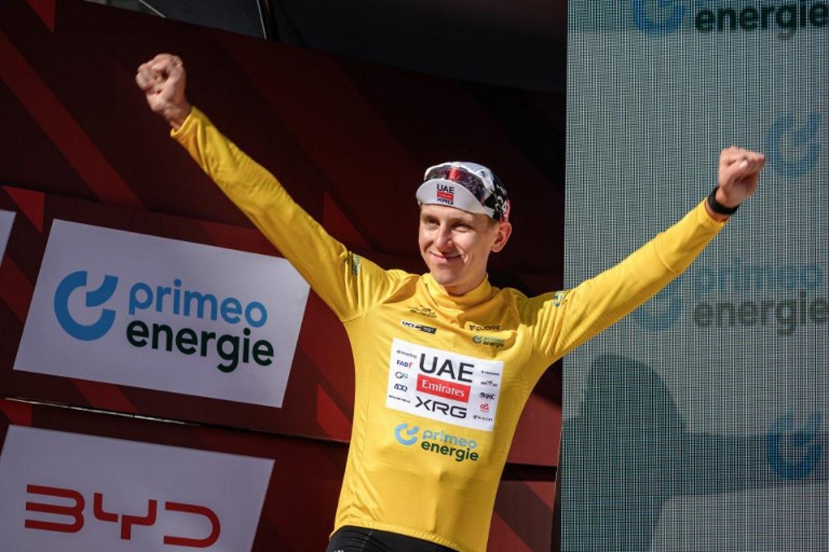 UAE Team Emirates-XRG's Slovenian rider Tadej Pogacar wearing the overall leader's yellow jersey celebrates on the podium of the fourth stage, a 23.7 km time trial from Aarburg to Aarburg, at the Men's Tour of Switzerland (Tour de Suisse) cycling race in Aarburg, Switzerland, on June 20, 2026.  Fabrice COFFRINI / AFP