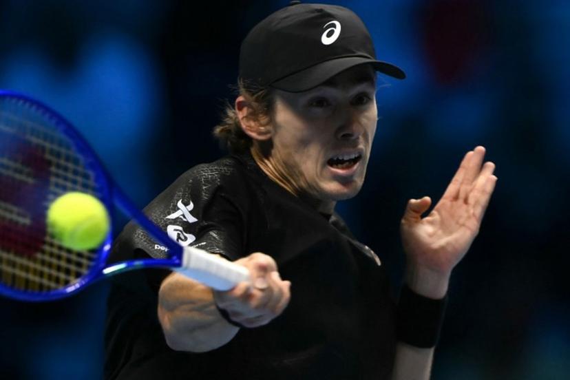 Australia's Alex De Minaur hits the ball during his match against Italy's Lorenzo Musetti at the ATP Finals tennis tournament in Turin on November 11, 2025.  Marco BERTORELLO / AFP