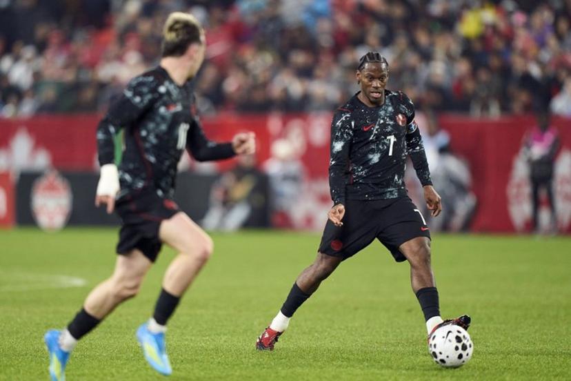 Canada's forward #07 Jonathan David (R) controls the ball during a friendly football match between Canada and Tunisia at BMO Field in Toronto, Canada, on March 31, 2026.  Geoff Robins / AFP