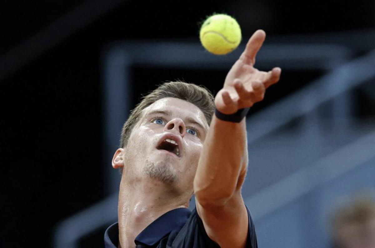 Belgium's Alexander Blockx tosses the ball into the air prior to serving against Germany's Alexander Zverev during their 2026 ATP Tour Madrid Open tennis tournament semi-final singles match at the Caja Magica in Madrid, on May 1, 2026.  OSCAR DEL POZO / AFP