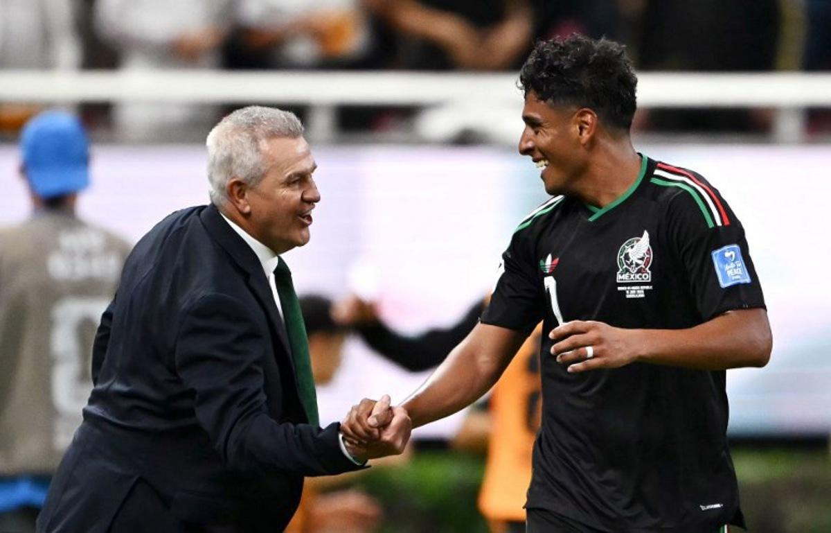Mexico's midfielder #07 Luis Romo celebrates with head coach Javier Aguirre scoring his team's first goal during the 2026 World Cup Group A football match between Mexico and South Korea at the Guadalajara Stadium in Zapopan on June 18, 2026.   CARL DE SOUZA / AFP