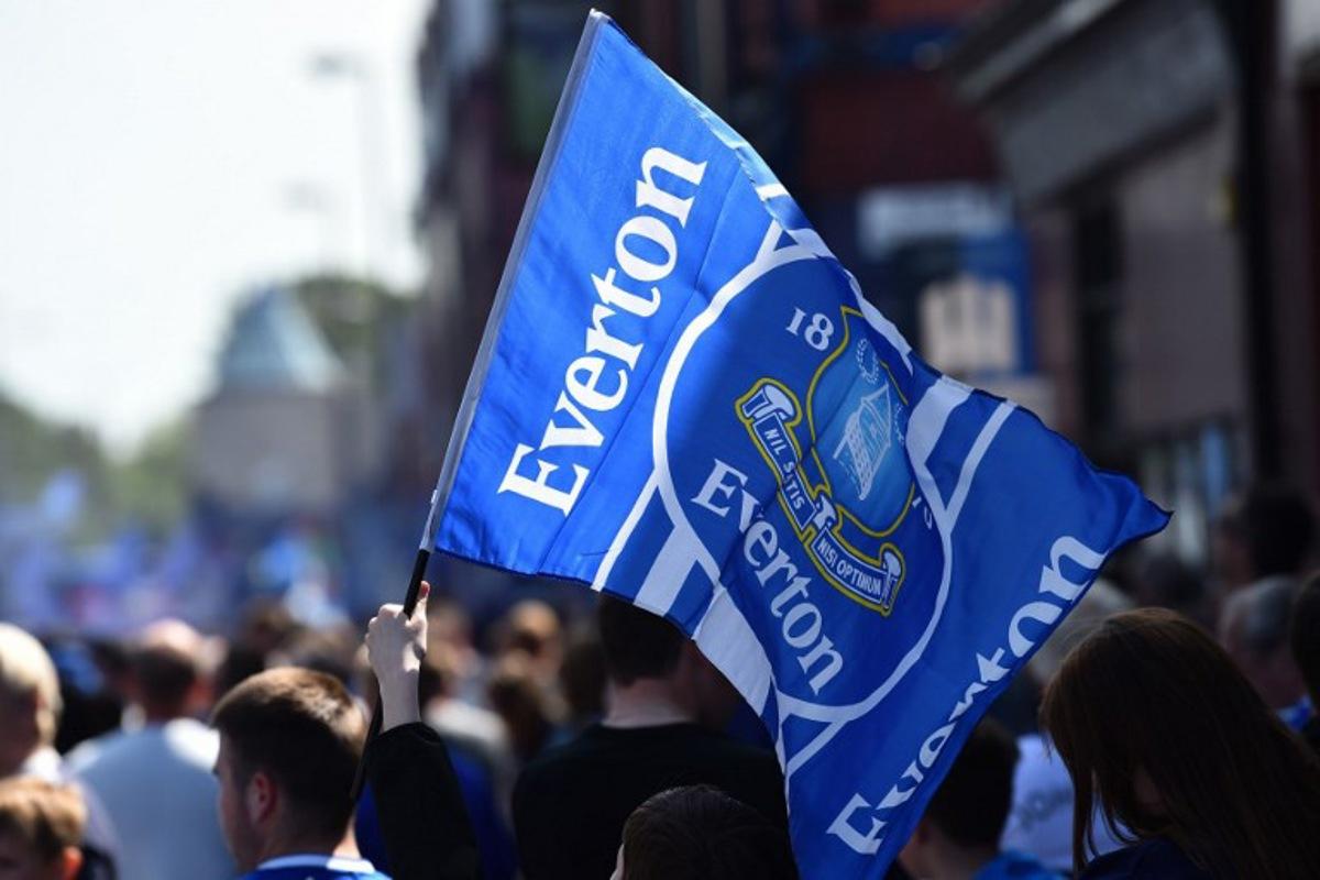 Everton supporters wave the club's flag before the start of the English Premier League football match between Everton and Bournemouth at Goodison Park in Liverpool, north west England on May 28, 2023.  PETER POWELL / AFP