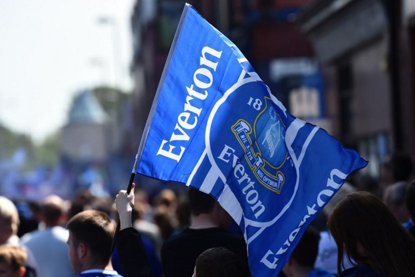 Everton supporters wave the club's flag before the start of the English Premier League football match between Everton and Bournemouth at Goodison Park in Liverpool, north west England on May 28, 2023.  PETER POWELL / AFP