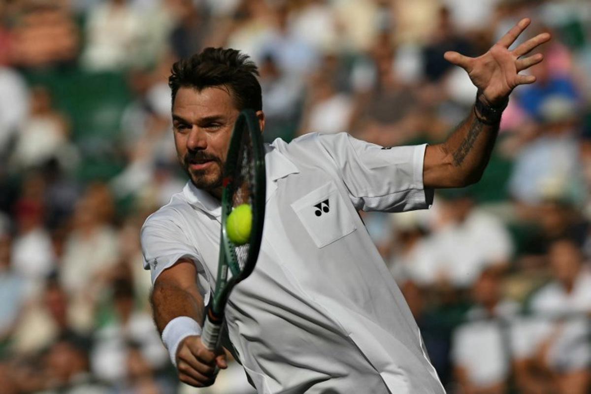 Switzerland's Stan Wawrinka returns to Italy's Matteo Berrettini during their men's singles first round tennis match on the second day of the 2026 Wimbledon Championships at The All England Lawn Tennis and Croquet Club in Wimbledon, southwest London, on June 30, 2026.  Glyn KIRK / AFP