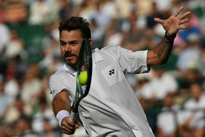 Switzerland's Stan Wawrinka returns to Italy's Matteo Berrettini during their men's singles first round tennis match on the second day of the 2026 Wimbledon Championships at The All England Lawn Tennis and Croquet Club in Wimbledon, southwest London, on June 30, 2026.  Glyn KIRK / AFP