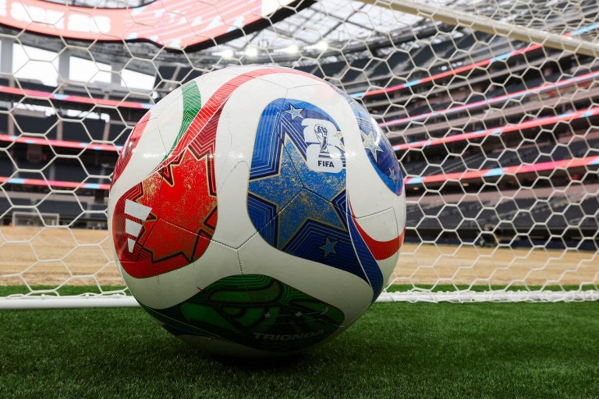 A giant ball is displayed behind a goal as an expanded pitch surface area, which required the removal of corner seating and a raised custom field platform, awaits the installation of grass during the 30 Days to FIFA World Cup 2026 media event at SoFI Stadium before the pitch installation and temporary renaming to Los Angeles Stadium in Inglewood, California on May 12, 2026. The US Men's National Team will play their first 2026 FIFA World Cup match on June 12 against Paraguay. Patrick T. Fallon / AFP