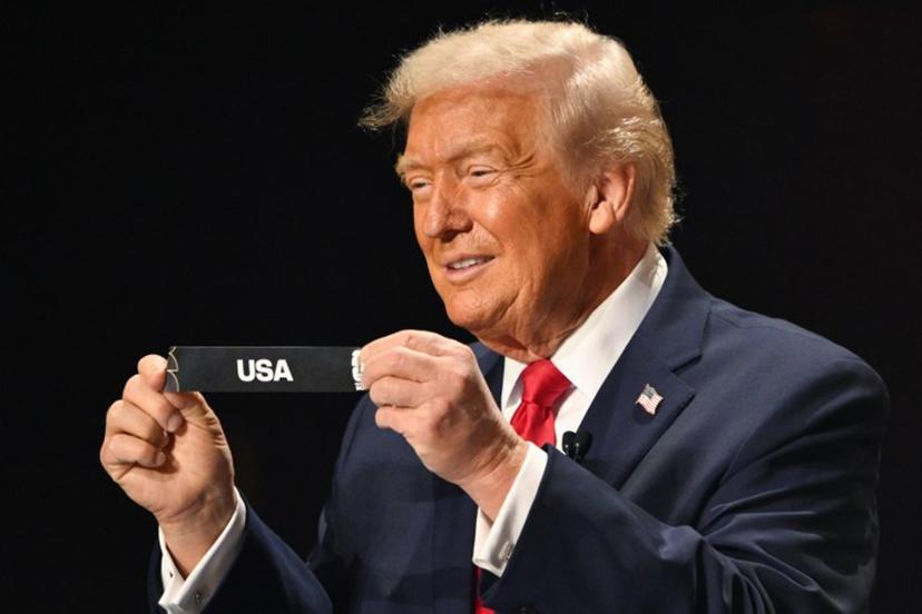 US President Donald Trump shows the card reading USA during the draw for the 2026 FIFA Football World Cup taking place in the US, Canada and Mexico, at the Kennedy Center, in Washington, DC, on December 5, 2025.  Mandel NGAN / POOL / AFP