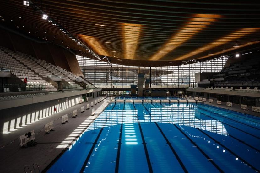 This photograph taken on March 28, 2024 shows the swimming pools and diving boards, in the Aquatics Centre built for the Paris 2024 Olympic Games to be used for artistic swimming, diving and water polo competitions in Saint Denis, near Paris.  Dimitar DILKOFF / AFP