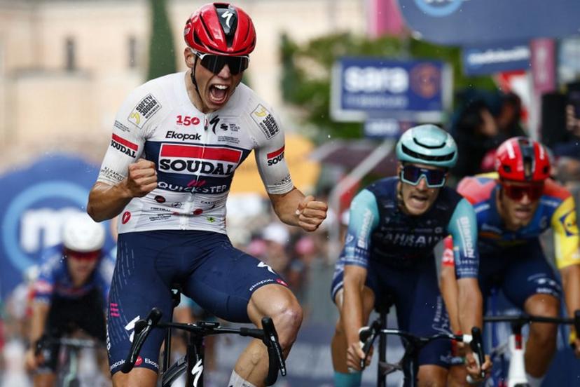 Soudal Quick-Step French rider Paul Magnier celebrates as he crosses the finish line to win the 18th stage of the Giro d'Italia 2026 - Tour of Italy cycling race between Fai della Paganella and Pieve di Soligo, Italy, on May 28, 2026. Magnier won the stage ahead of Bahrain - Victorious Italian rider Edoardo Zambanini and Lidl - Trek Italian rider Jonathan Milan (R). Luca Bettini / AFP