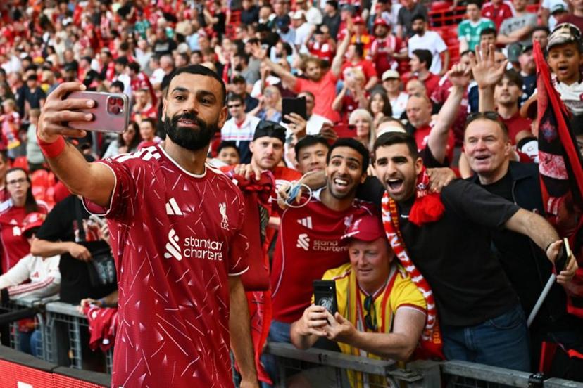 Liverpool's Egyptian striker #11 Mohamed Salah takes a selfie with fans after the English Premier League football match between Liverpool and Brentford at Anfield in Liverpool, north west England on May 24, 2026.  Paul ELLIS / AFP