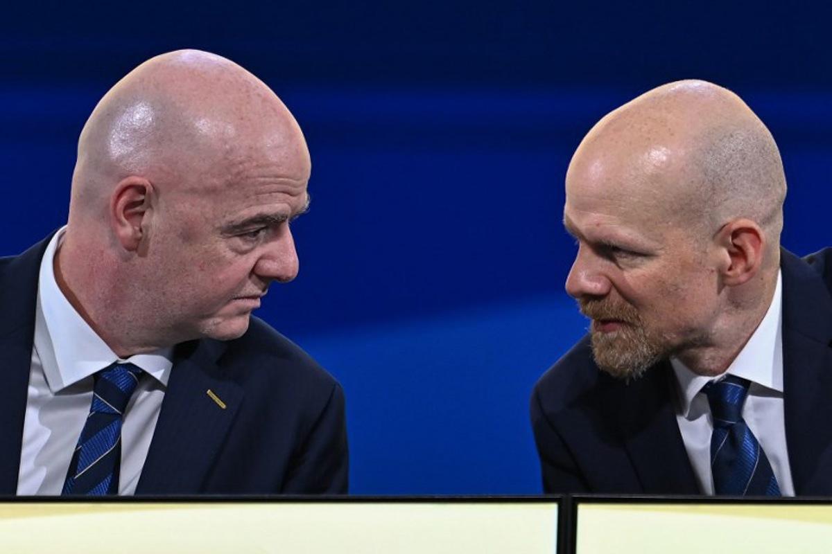 FIFA President Gianni Infantino (L) speaks with FIFA Secretary-General Mattias Grafstrom (R) during the 74th FIFA Congress in Bangkok on May 17, 2024. The 74th FIFA Congress is taking place in Bangkok with member associations voting on a range of issues including confirmation of the host nation or nations for the 2027 women's football World Cup. Manan VATSYAYANA / AFP