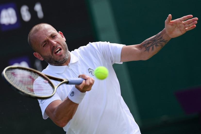 Britain's Daniel Evans plays a forehand return to Britain's Jay Clarke during their men's singles first round tennis match on the second day of the 2025 Wimbledon Championships at The All England Lawn Tennis and Croquet Club in Wimbledon, southwest London, on July 1, 2025.  Adrian Dennis / AFP