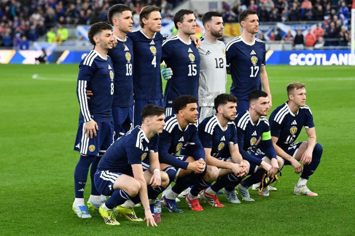 (Back row L-R) Scotland's midfielder #08 Billy Gilmour, Scotland's striker #18 George Hirst, Scotland's midfielder #04 Scott McTominay, Scotland's defender #15 John Souttar, Scotland's goalkeeper #12 Liam Kelly and Scotland's defender Dominic Hyam, (Front row L-R) Scotland's defender #06 Kieran Tierney, Scotland's forward #10 Che Adams, Scotland's forward #11 Ryan Christie, Scotland's defender #03 Andrew Robertson and Scotland's midfielder #16 Ross McCrorie pose for a team photo ahead of the friendly international football match between Scotland and Ivory Coast at the Hill Dickinson Stadium in Liverpool, north west England on March 31, 2026.    PETER POWELL / AFP
