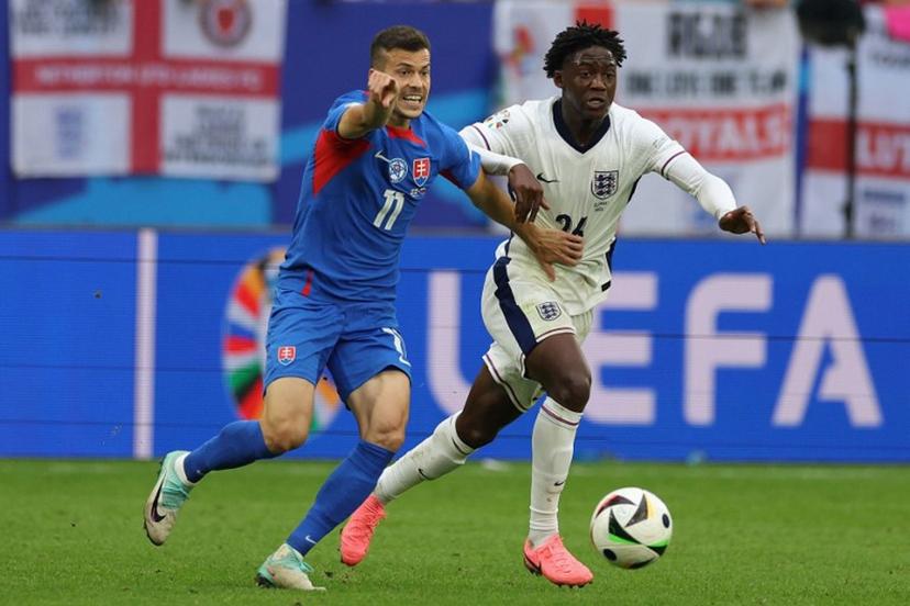 Slovakia's midfielder #11 Laszlo Benes fights for the ball with England's midfielder #26 Kobbie Mainoo during the UEFA Euro 2024 round of 16 football match between England and Slovakia at the Arena AufSchalke in Gelsenkirchen on June 30, 2024.  Adrian DENNIS / AFP