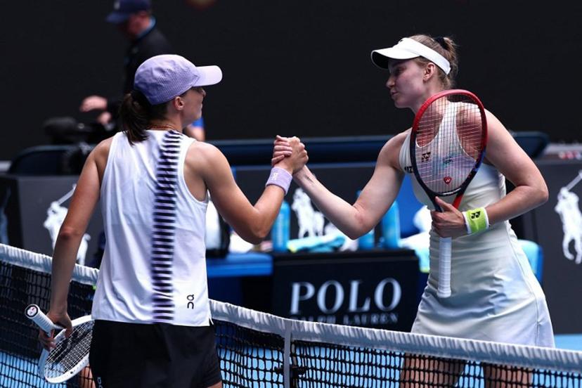 Kazakhstan's Elena Rybakina (R) shakes hands with Poland's Iga Swiatek after their women's singles quarter-final match on day eleven of the Australian Open tennis tournament in Melbourne on January 28, 2026.  IZHAR KHAN / AFP