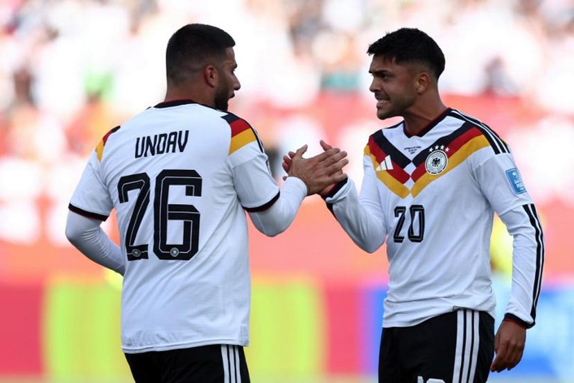 Germany's forward #26 Deniz Undav (L) is congratulated by Germany's midfielder #20 Nadiem Amiri after scoring his team's first goal during the 2026 World Cup Group E football match between Germany and Ivory Coast at the Toronto Stadium in Toronto on June 20, 2026.   Cole Burston / AFP
