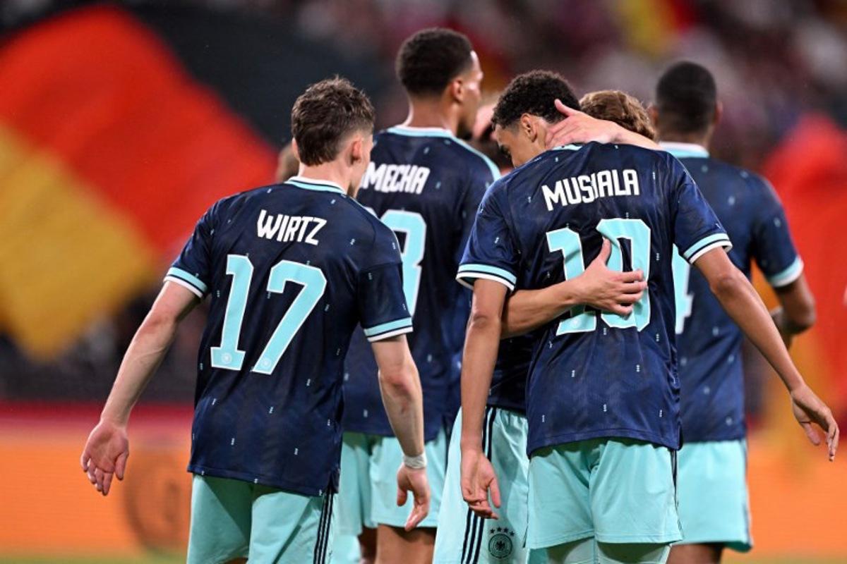 Germany's midfielder #10 Jamal Musiala (R) celebrates scoring his team's fourth goal with teammate Germany's midfielder #17 Florian Wirtz and others during a friendly match between Germany and Finland ahead of the 2026 FIFA World Cup football tournament, in Mainz, western Germany on May 31, 2026.  Kirill KUDRYAVTSEV / AFP