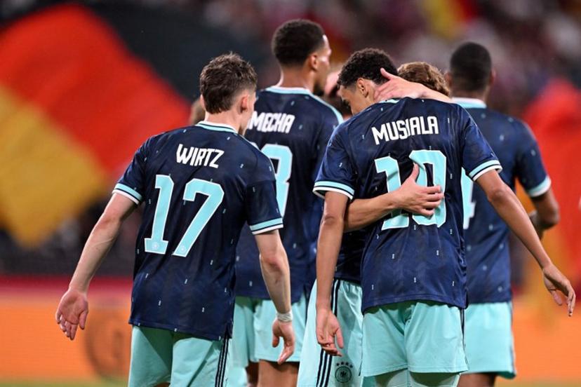 Germany's midfielder #10 Jamal Musiala (R) celebrates scoring his team's fourth goal with teammate Germany's midfielder #17 Florian Wirtz and others during a friendly match between Germany and Finland ahead of the 2026 FIFA World Cup football tournament, in Mainz, western Germany on May 31, 2026.  Kirill KUDRYAVTSEV / AFP