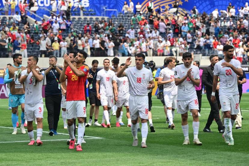 Iran's players celebrate at the end of the 2026 World Cup Group G football match between Belgium and Iran at the Los Angeles Stadium in Inglewood on June 21, 2026.   Frederic J. Brown / AFP